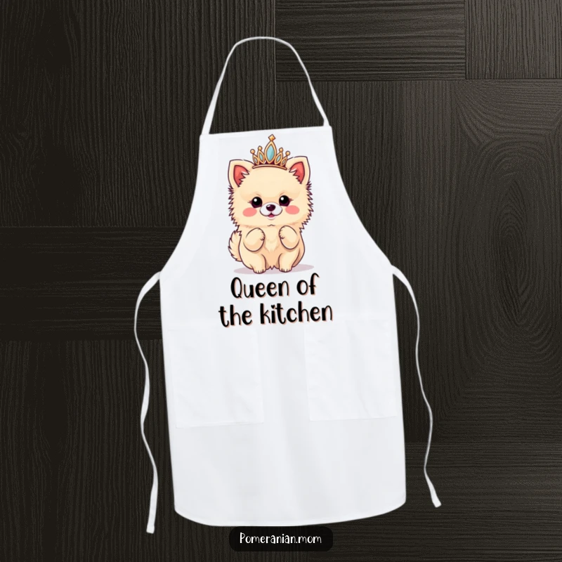 Funny apron showcasing a kawaii Pomeranian queen wearing a tiny tiara and striking a diva pose while cooking with flair.