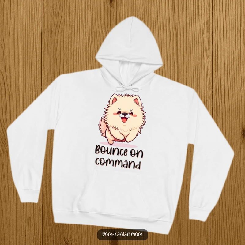Funny Kawaii Pomeranian hoodie showing a small dog in an excited bounce, radiating playful energy.