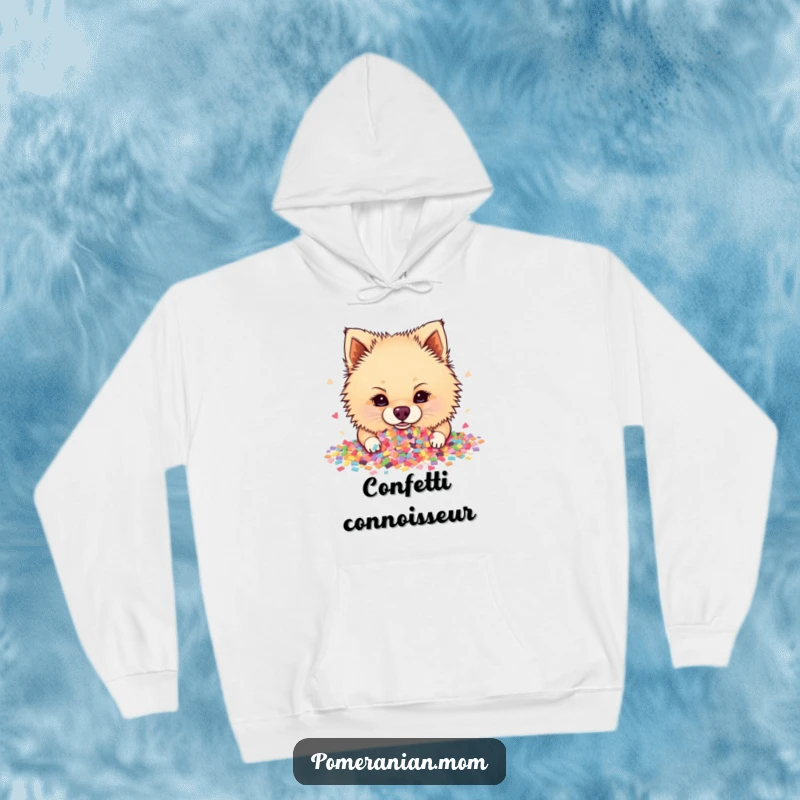Funny Pomeranian hoodie featuring a joyful dog enthusiastically digging its nose into a massive, colorful pile of scattered confetti.