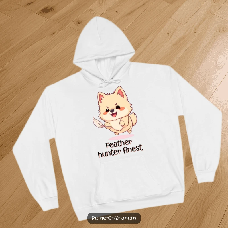 Funny Pomeranian hoodie showing a happy dog in mid-air, enthusiastically chasing a small feather, radiating pure playful energy and joy.