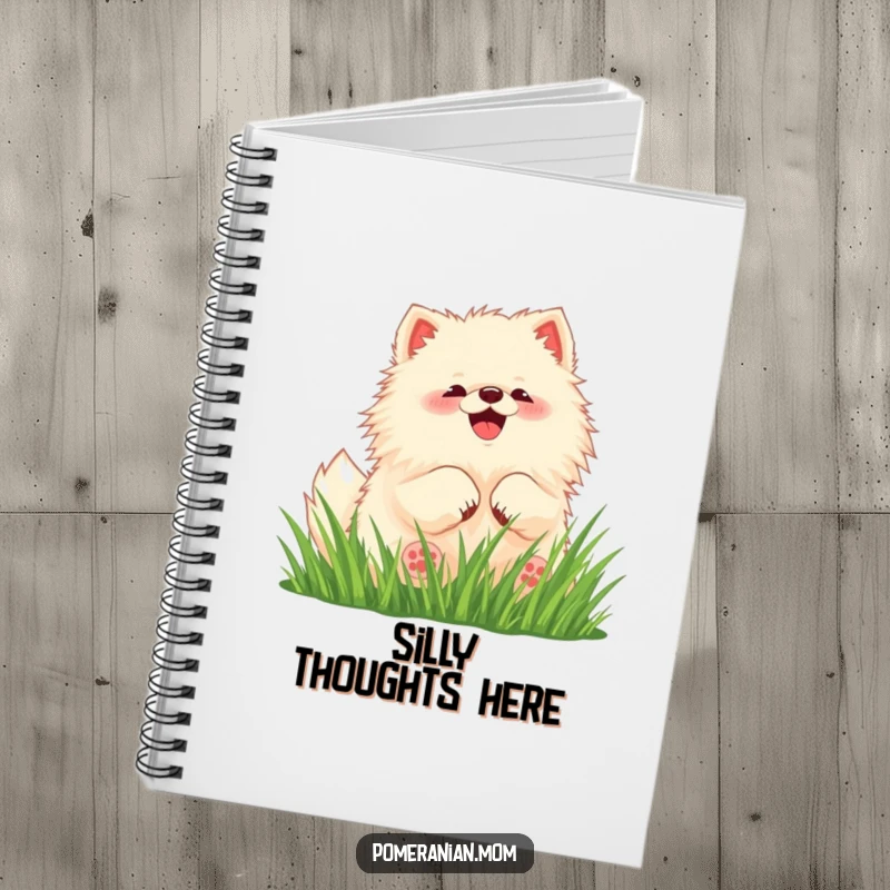 Funny Pomeranian notebook featuring a kawaii dog rolling happily in grass, ideal for journaling.