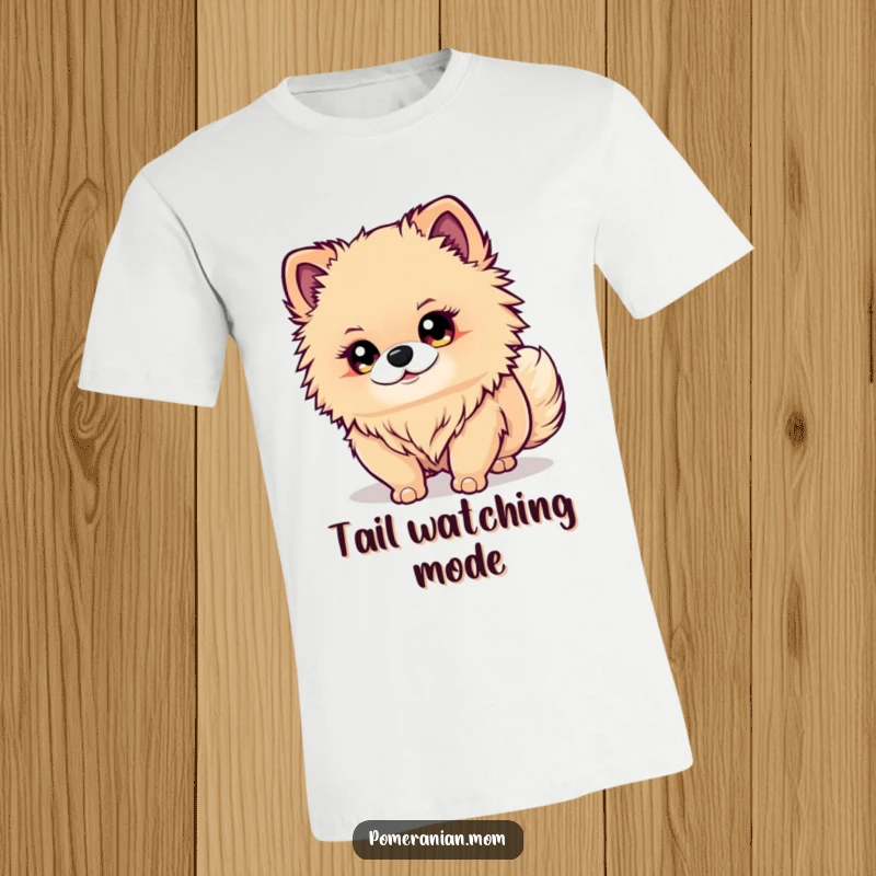 Funny Kawaii Pomeranian T-Shirt: A cute dog with bright eyes intently watches its wagging tail, capturing humorous canine focus.